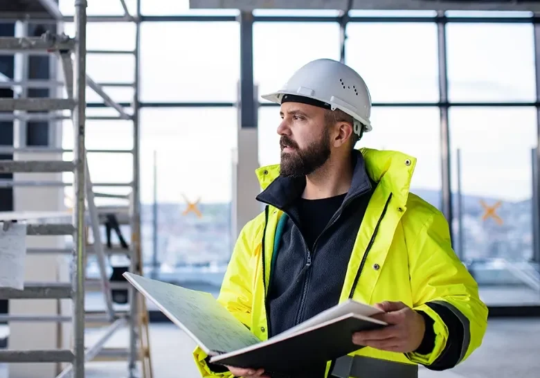 construction-worker-holding-book-of-plans